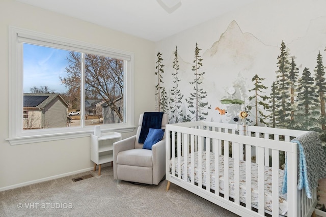 bedroom with visible vents, carpet floors, a nursery area, and baseboards