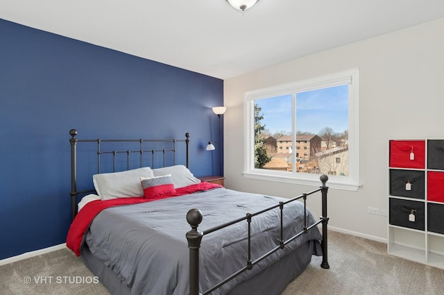 carpeted bedroom featuring baseboards