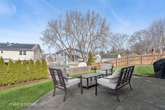 view of patio with grilling area, an outdoor hangout area, and a fenced backyard