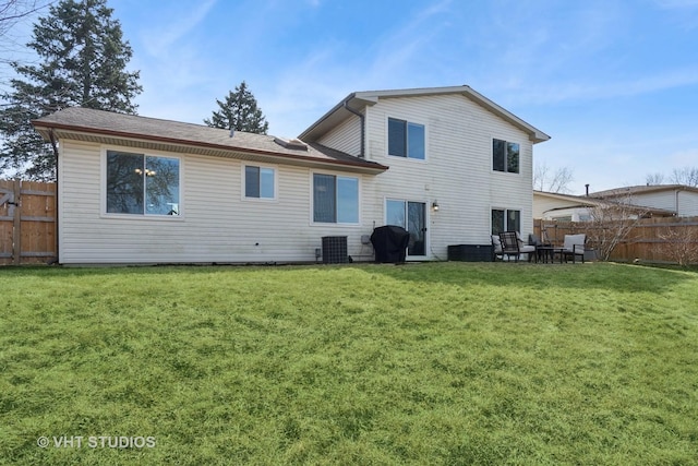 back of property with a patio area, central AC, a yard, and fence