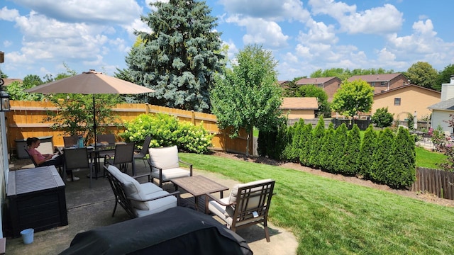 view of yard featuring outdoor dining space, a patio, and a fenced backyard