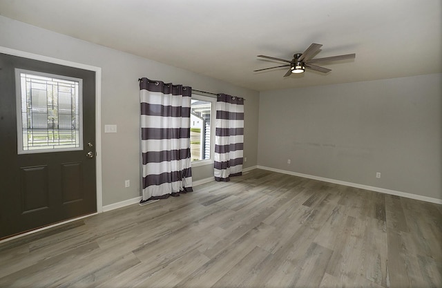 entryway featuring ceiling fan, baseboards, and wood finished floors