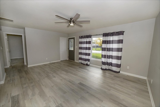 unfurnished bedroom with baseboards, light wood-style flooring, and a ceiling fan