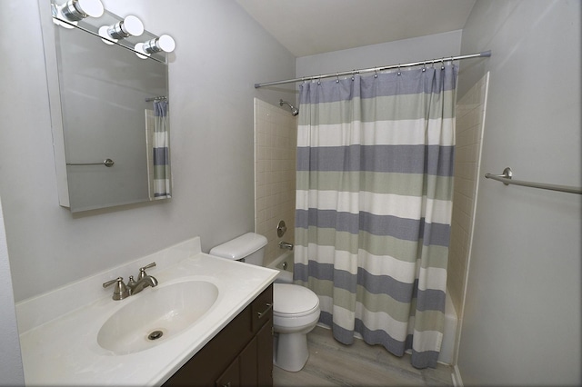 full bath with toilet, vanity, and wood finished floors