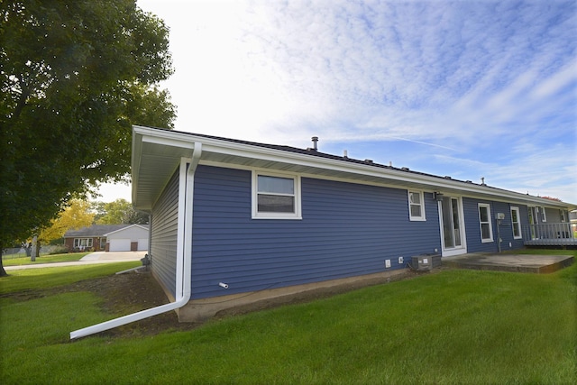 back of house with a yard and central AC