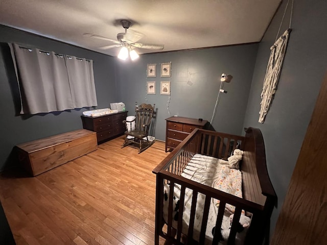 bedroom with light wood finished floors and a ceiling fan