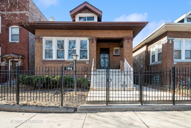 view of front of property with brick siding and a fenced front yard