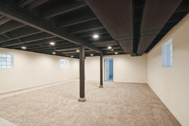 below grade area featuring baseboards and carpet floors