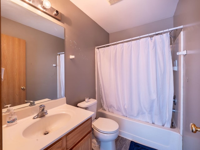 bathroom featuring vanity, shower / tub combo, and toilet