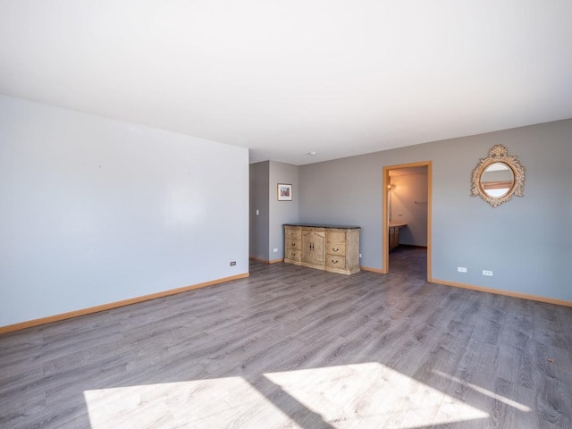 unfurnished living room featuring light wood-style floors and baseboards