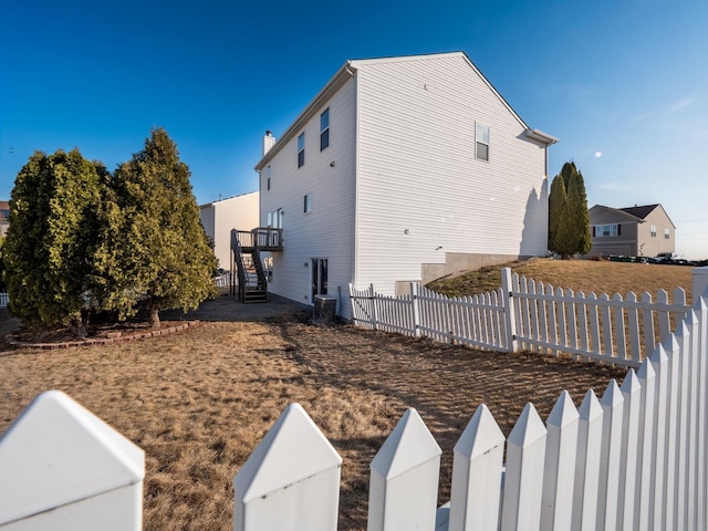 view of property exterior with fence private yard