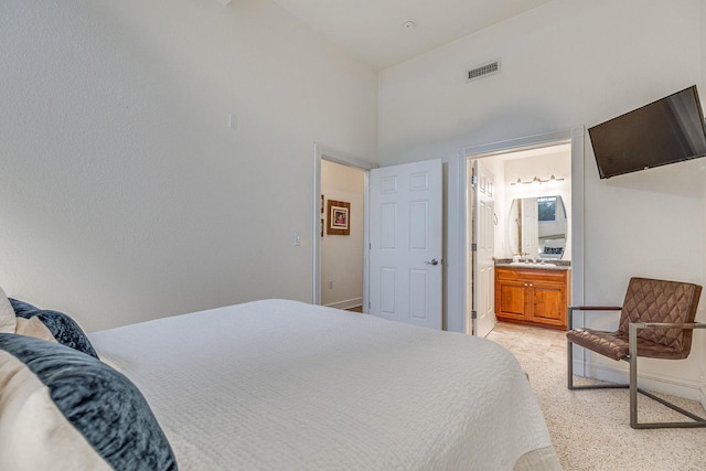 bedroom featuring visible vents, baseboards, and ensuite bath