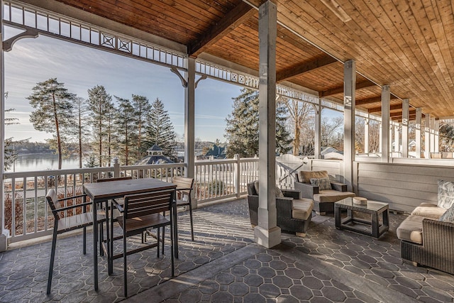 view of patio / terrace with outdoor lounge area, outdoor dining space, and a water view