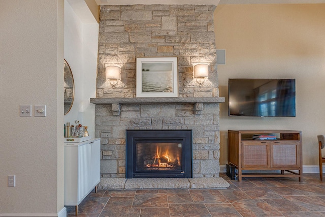 room details with a fireplace, radiator, and baseboards