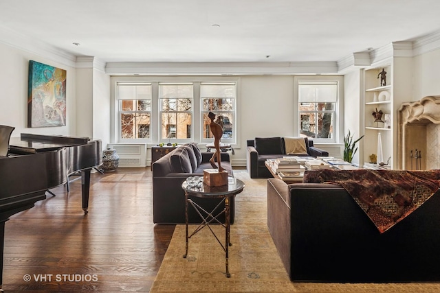 living room with a wealth of natural light, wood finished floors, and ornamental molding