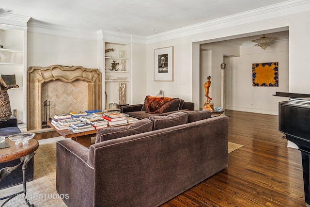 living room featuring built in features, crown molding, baseboards, and wood finished floors