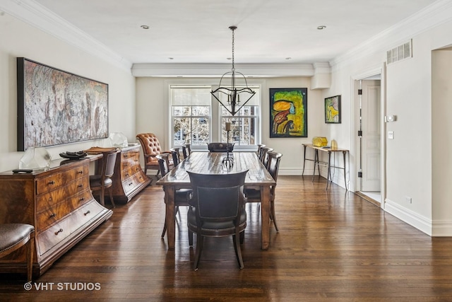 dining space with visible vents, dark wood-type flooring, an inviting chandelier, and ornamental molding