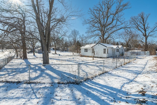 snowy yard with a fenced front yard