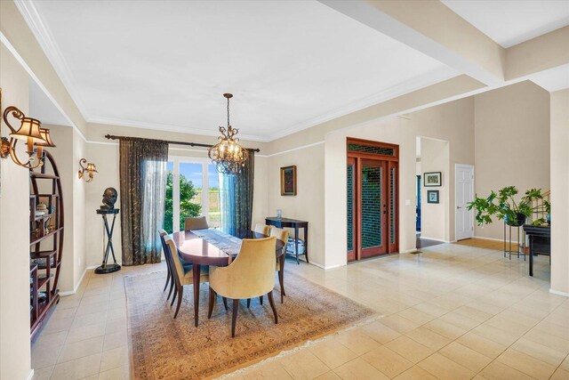 dining area with light tile patterned floors, a chandelier, crown molding, and baseboards