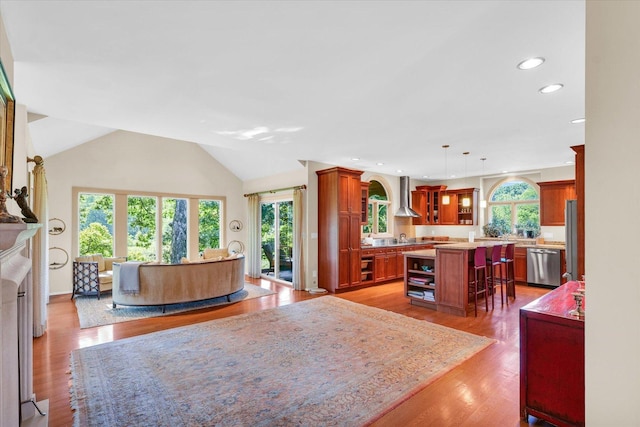 living room featuring recessed lighting, wood finished floors, and vaulted ceiling