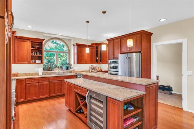 kitchen featuring wine cooler, appliances with stainless steel finishes, brown cabinetry, and open shelves