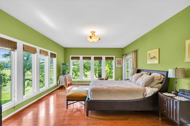 bedroom featuring baseboards and wood finished floors