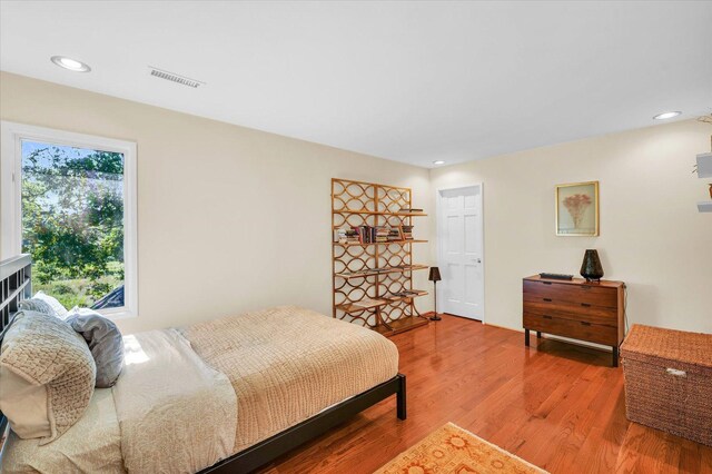 bedroom with recessed lighting, visible vents, and light wood finished floors