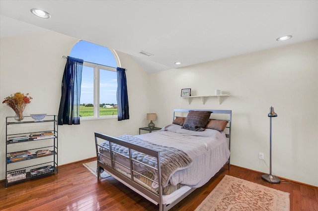 bedroom with recessed lighting, visible vents, lofted ceiling, and wood finished floors