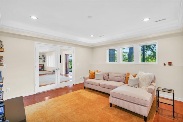 living area featuring visible vents, ornamental molding, recessed lighting, french doors, and wood finished floors