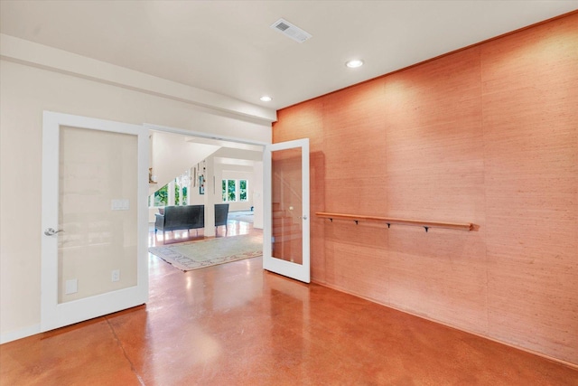 unfurnished room featuring visible vents, concrete floors, baseboards, recessed lighting, and french doors