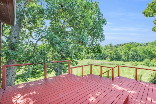 wooden deck featuring a lawn