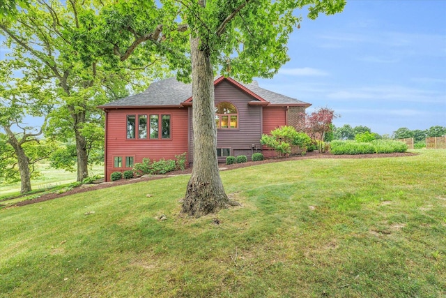 view of side of property with a lawn