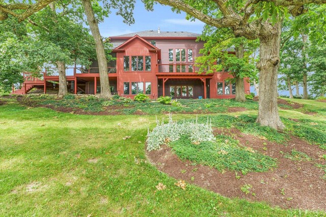 back of house with a lawn and a wooden deck