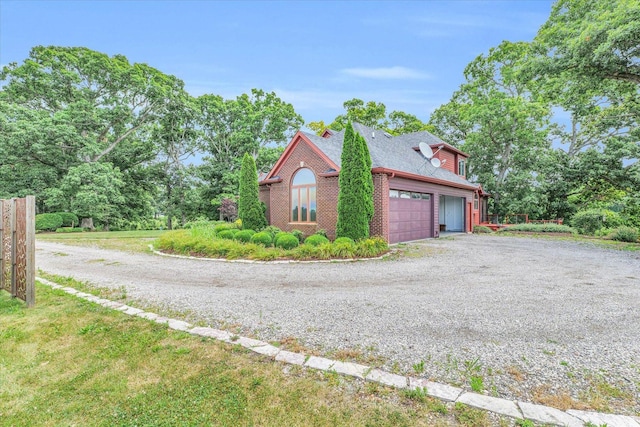 view of side of property with brick siding and driveway