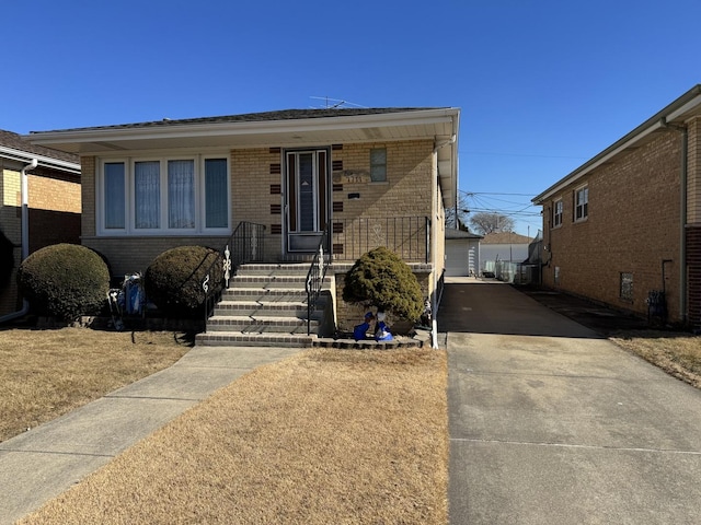 view of front of house featuring brick siding and an outdoor structure