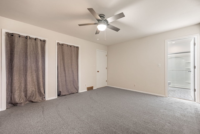 unfurnished bedroom featuring ensuite bath, baseboards, and carpet floors