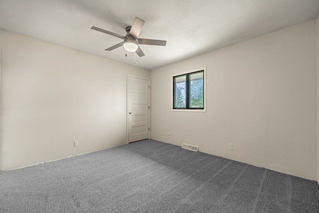 unfurnished room featuring visible vents, carpet flooring, and ceiling fan