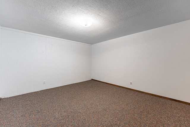 carpeted empty room with a textured ceiling