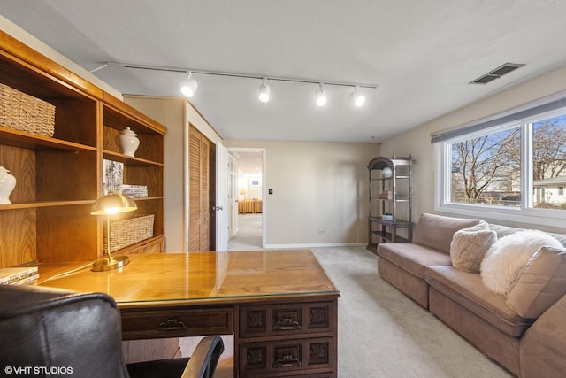 office area featuring visible vents, baseboards, and light colored carpet