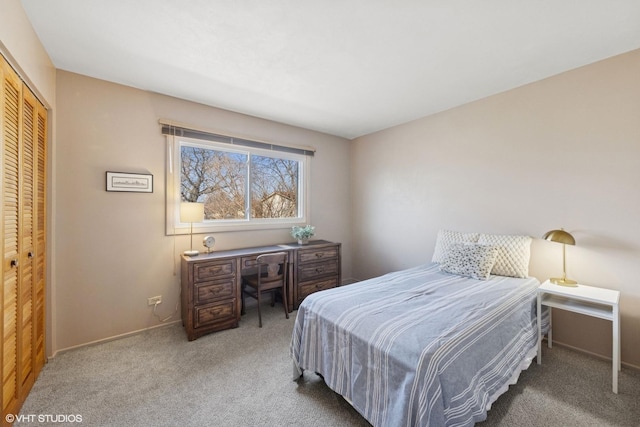 bedroom with a closet, baseboards, and carpet