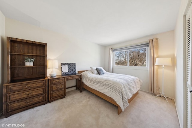 bedroom featuring light carpet