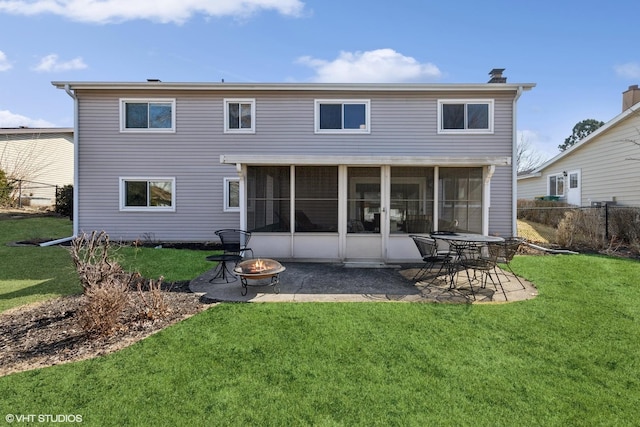 rear view of property with fence, an outdoor fire pit, a sunroom, a patio area, and a lawn