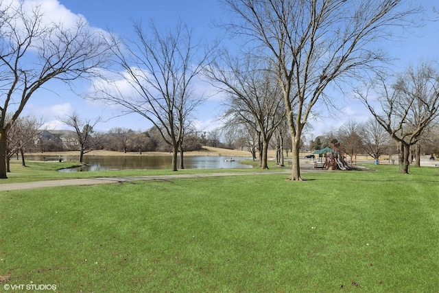 view of yard with playground community and a water view