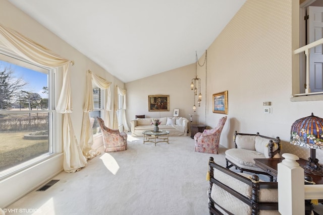 living room featuring vaulted ceiling, carpet flooring, and visible vents