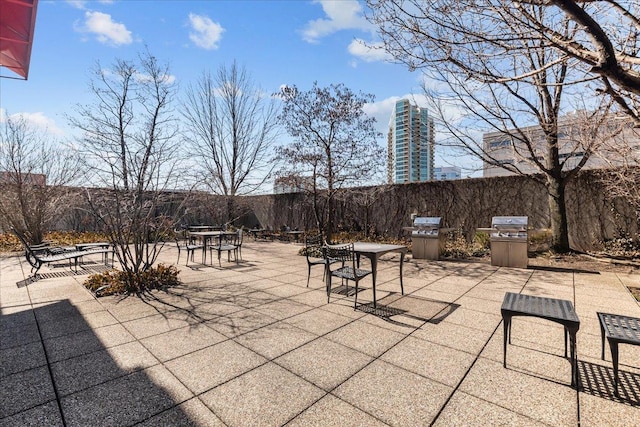 view of patio with a grill and fence