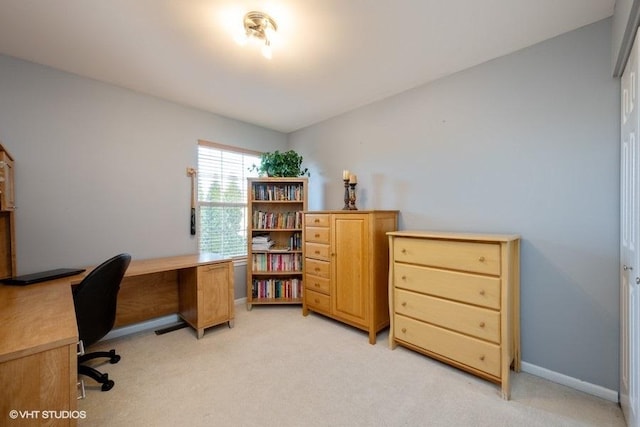 office featuring baseboards and light colored carpet