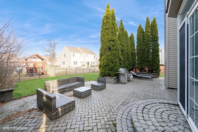 view of patio with a residential view, an outdoor living space, a playground, and a fenced backyard