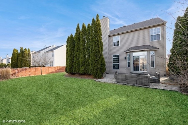 rear view of house with a yard, a patio, an outdoor hangout area, and fence