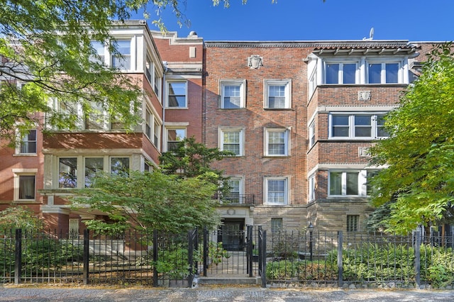 view of building exterior with a fenced front yard