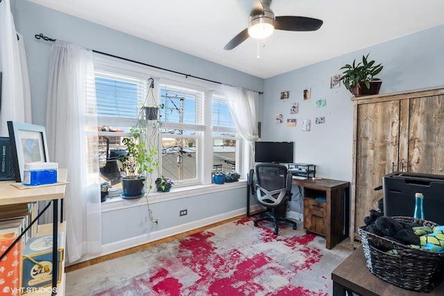 office featuring ceiling fan, baseboards, and wood finished floors